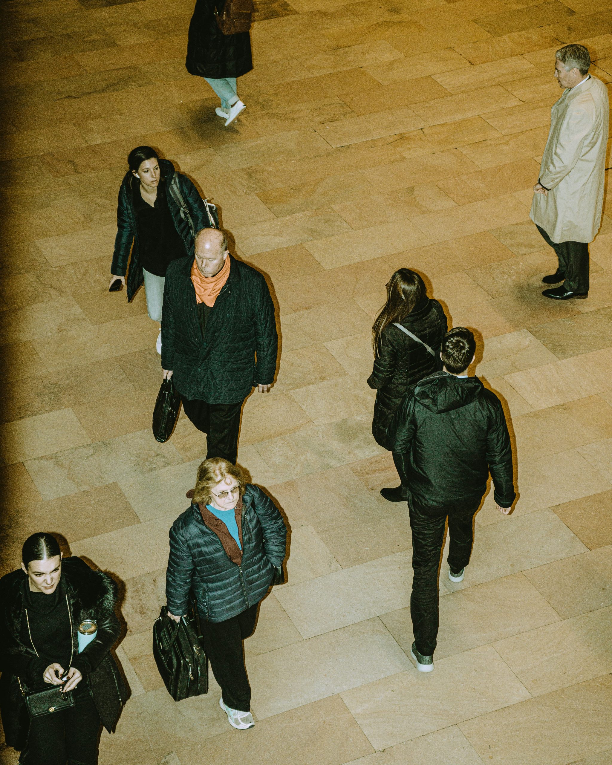 People crossing a busy public concourse